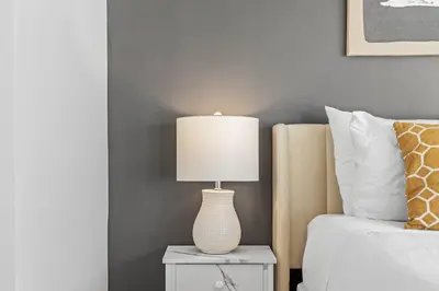 a lamp on a night stand next to a bed at B233 Mountain View 2BD 2BT AC BonFire BBQ Townhome Close to Banff in Canmore