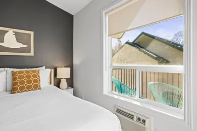 a bedroom with a bed and a window at B233 Mountain View 2BD 2BT AC BonFire BBQ Townhome Close to Banff in Canmore