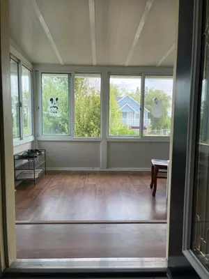 an empty living room with windows and a table at Big band home in Burnaby