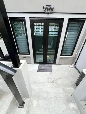 a front door of a building with glass windows at Private Rooms in Vancouver West in Vancouver