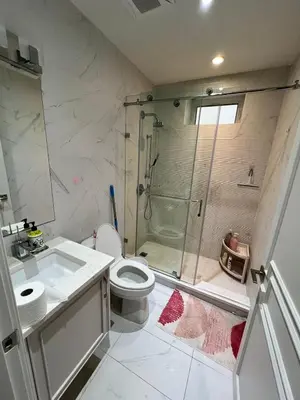 a bathroom with a shower and a toilet and a sink at Private Rooms in Vancouver West in Vancouver