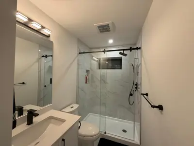 a bathroom with a shower and a toilet and a sink at Calm & Cozy Private Suite in Surrey