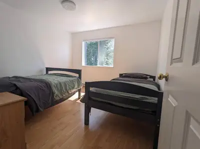 a bedroom with two beds and a window at Charming 3 Bedroom Suite in Victoria