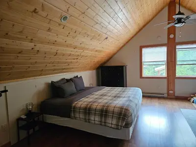 a bedroom with a bed with a wooden ceiling at Carriage House - 2 suites- HIKE & REST - EV plug in Golden