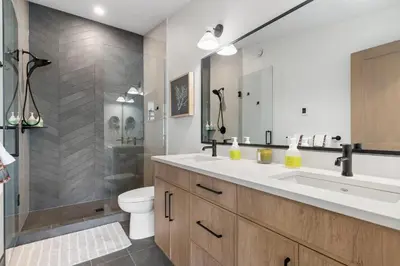 a bathroom with a sink and a toilet and a shower at Luxe Retreat by Canadian Rockies Vacation Rentals in Canmore