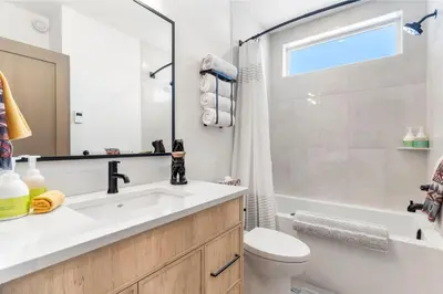 a bathroom with a sink and a tub and a toilet at Luxe Retreat by Canadian Rockies Vacation Rentals in Canmore