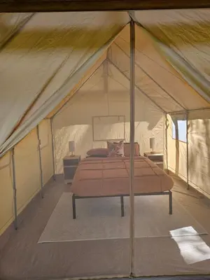 a bedroom in a tent with a bed in it at Zest Campers Ltd in Golden