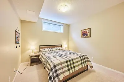 a small bedroom with a bed and a window at sweet home in Calgary