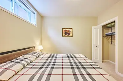 a bedroom with a bed with a checkered floor at sweet home in Calgary