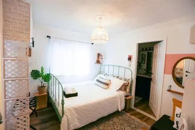 a bedroom with a bed and a potted plant at Chic Artistic Studio Suite Exceptional Luxury with Everything You Need NO need to SHARE Room in Richmond