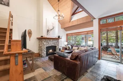 a living room with a couch and a fireplace at Montebello 4877 by Outpost Whistler in Whistler