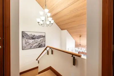 a staircase in a house with a wooden ceiling at Montebello 4877 by Outpost Whistler in Whistler