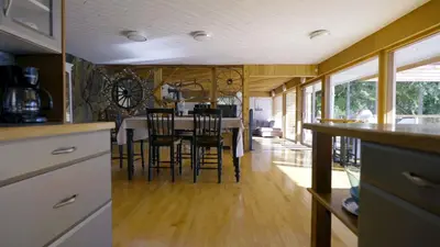 a kitchen and dining room with a table and chairs at Ozarks Luxurious Lakeside Villa at Harrison Lake in Harrison Hot Springs