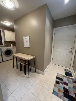 a kitchen with a table and a door in a room at Zp Home in Richmond