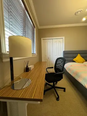 a bedroom with a desk and a bed and a chair at Zp Home in Richmond