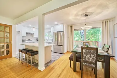 an open kitchen and dining room with a table and chairs at Chinook Executive Entire House in Calgary