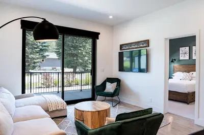 a living room with a couch and a table at Rustic Retreat by Revelstoke Vacations in Revelstoke