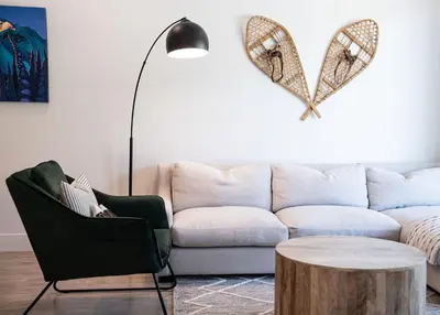 a living room with a couch with a heart on the wall at Rustic Retreat by Revelstoke Vacations in Revelstoke