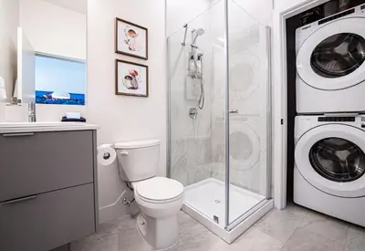 a bathroom with a washing machine and a toilet at Rustic Retreat by Revelstoke Vacations in Revelstoke