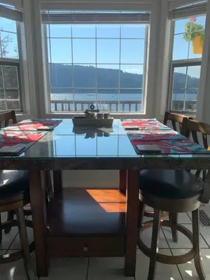 a dining room table with a view of the water at Best Bed and Breakfast in Port Alberni