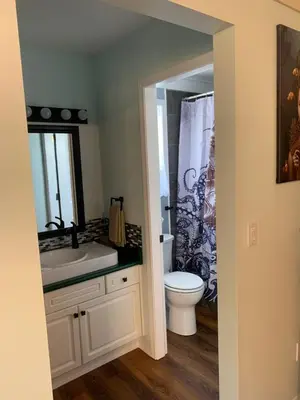 a bathroom with a white sink and a toilet at Best Bed and Breakfast in Port Alberni