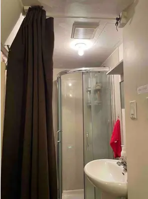 a bathroom with a shower and a sink at Cozy and Friendly Home Single Room No Pets Allowed in Burnaby