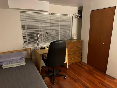 a bedroom with a desk and a chair and a window at Cozy and Friendly Home Single Room No Pets Allowed in Burnaby