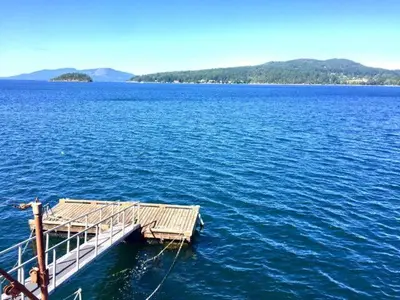 a dock in the middle of a large body of water at OCEAN FRONT 2 BEDROOM SUITE with STUNNING VIEWS in Victoria