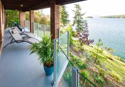 a porch with benches and a view of the water at OCEAN FRONT 2 BEDROOM SUITE with STUNNING VIEWS in Victoria