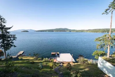 a view of a large lake with a house at OCEAN FRONT 2 BEDROOM SUITE with STUNNING VIEWS in Victoria