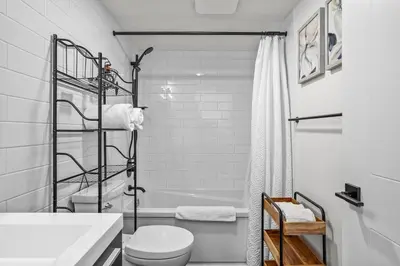 a white bathroom with a toilet and a shower at T202 BRAND NEW! The Mountain's Call- Mountain View Stay in Canmore