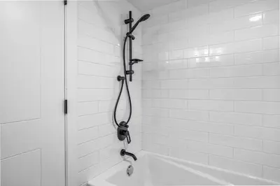 a shower in a white bathroom with a shower at T202 BRAND NEW! The Mountain's Call- Mountain View Stay in Canmore