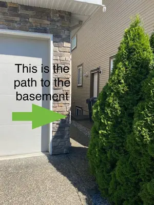 a garage door with a sign that reads this is the path to the assessment at Langley Heights 2 Bedrooms Sweet Suite in Langley