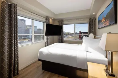 a hotel room with a bed and a large window at Baymont by Wyndham West Edmonton in Edmonton