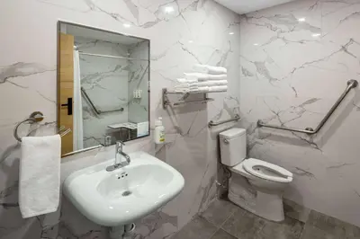 a white bathroom with a sink and a toilet at Baymont by Wyndham West Edmonton in Edmonton