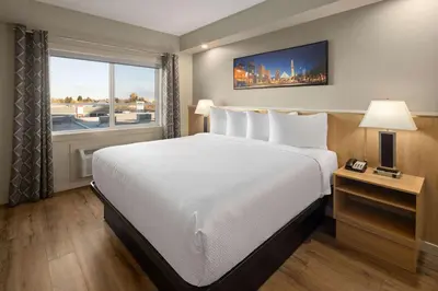 a hotel room with a large bed and a window at Baymont by Wyndham West Edmonton in Edmonton