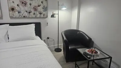 a bedroom with a bed and a chair with a bowl on a table at Cozy Retreat in Mission City