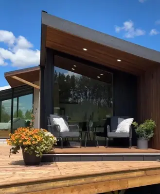a house with a deck with chairs and plants at Refuge Bay Caelum Cabin Luxury Off Grid Escape in Cherhill