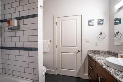 a white bathroom with a toilet and a sink at Downunder Mountain Retreat in Revelstoke