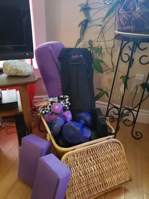 a basket filled with purple chairs and a table at Mission Historical Home in Calgary