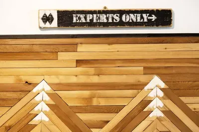 a wooden floor with a sign on a wall at Glacier Lodge Premiere Suite in Whistler