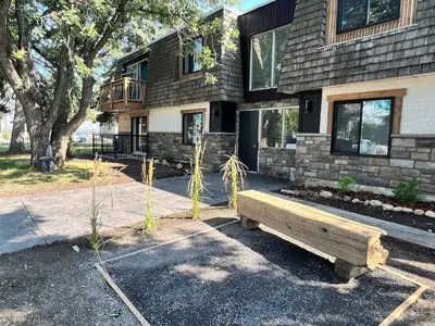 a wooden bench sitting in front of a building at Newly Renovated 1br1ba With Asian Style Tea Room in Edmonton