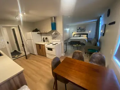 a kitchen and a living room with a table and chairs at Newly Renovated 1br1ba With Asian Style Tea Room in Edmonton