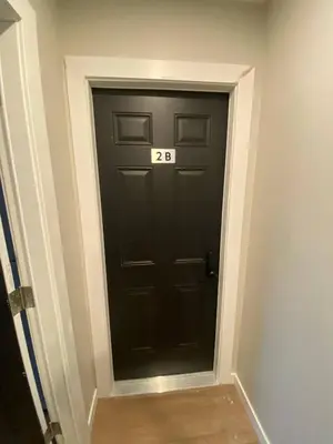 a black door with the number on it at Guest Suite Close To Whtye Ave in Edmonton