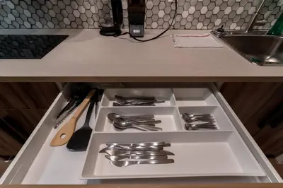 a drawer in a kitchen with silver utensils at Guest Suite Close To Whtye Ave in Edmonton