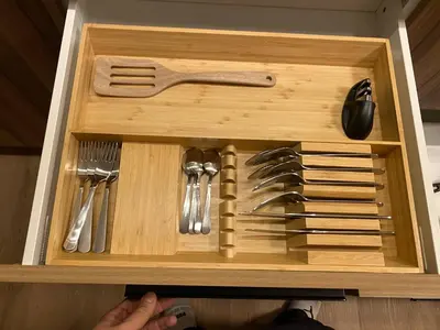 a wooden drawer with utensils in a wooden box at Guest Suite Close To Whtye Ave in Edmonton