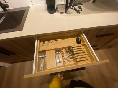 a drawer in a counter with utensils in it at Guest Suite Close To Whtye Ave in Edmonton