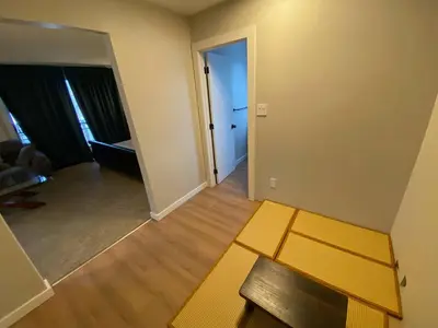 an empty living room with a couch and a table at Close To Whyte University New Renovation in Edmonton