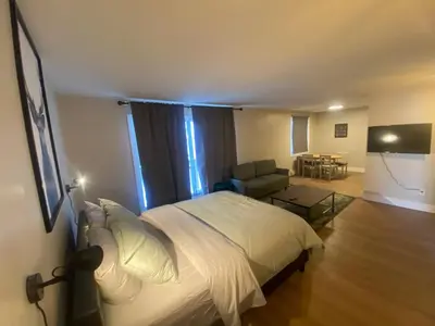 a bedroom with a bed and a chair and a table at Morden Newly Renovated 1br Flats, Walk To Whyte in Edmonton