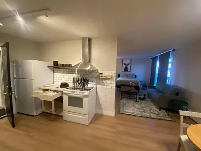 a kitchen and living room with a refrigerator and a stove at Morden Newly Renovated 1br Flats, Walk To Whyte in Edmonton